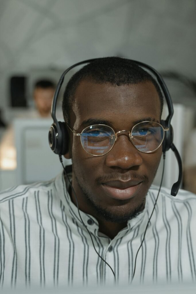 Confident call center agent with headphones providing customer service support.